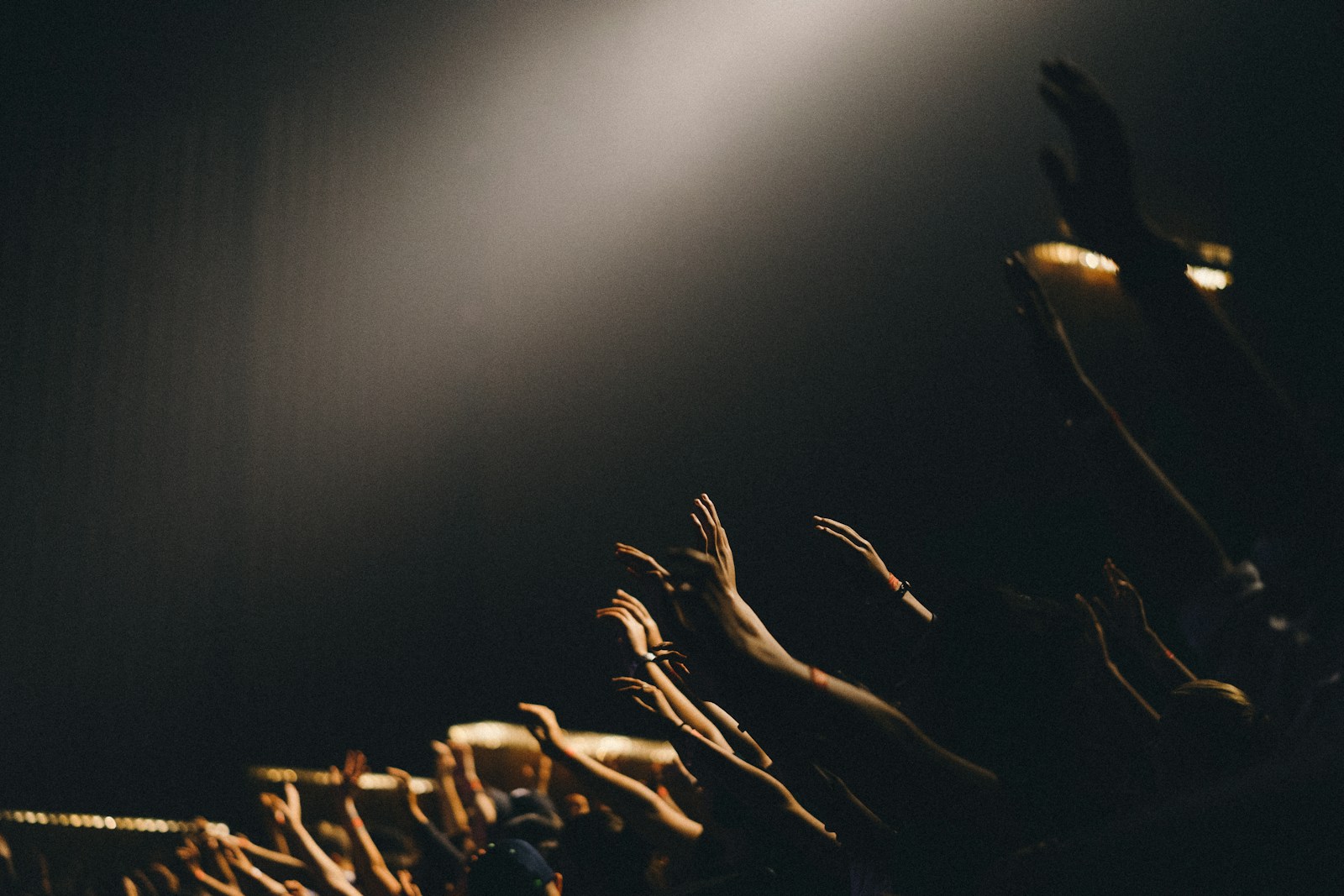 Group of worshippers waving their hands during Mighty Name of Jesus