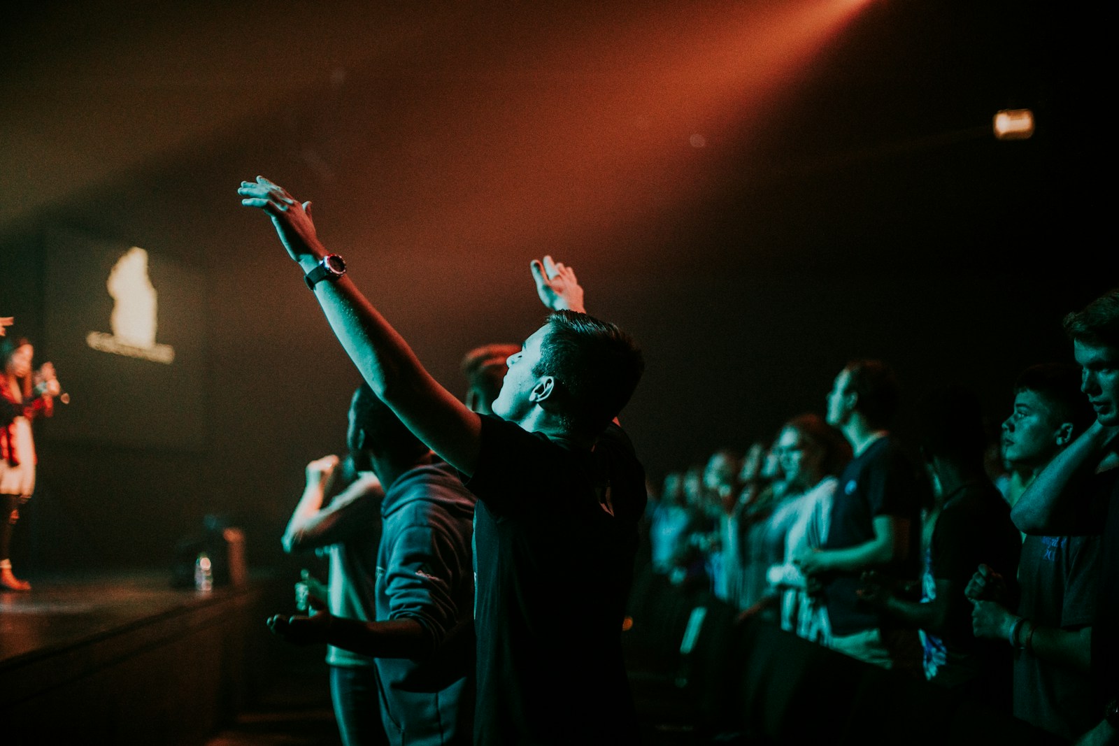 Worshippers gathered near the stage reflecting the In the Room meaning of God nearness